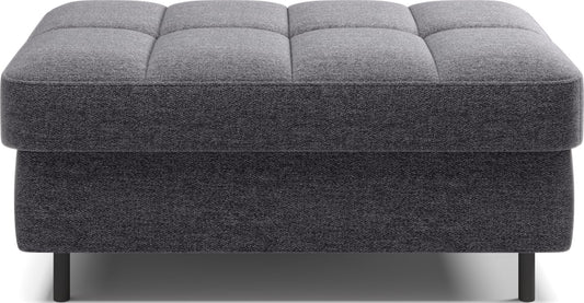 Pufa na białym tle, prostokątna, ciemnoszara z przeszyciami.