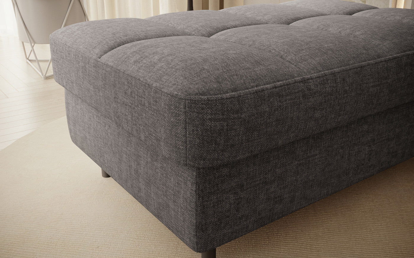 Pufa do siedzenia, prostokątna, szara z przeszyciami.