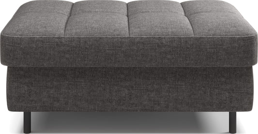 Pufa na białym tle, prostokątna, szara z przeszyciami.