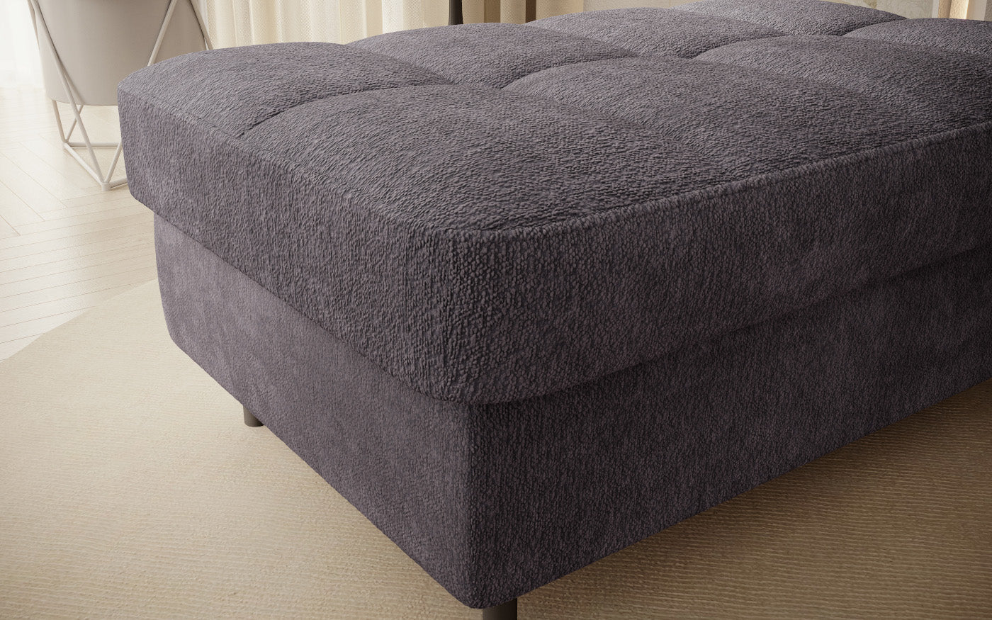 Pufa do siedzenia, prostokątna, szara z przeszyciami.