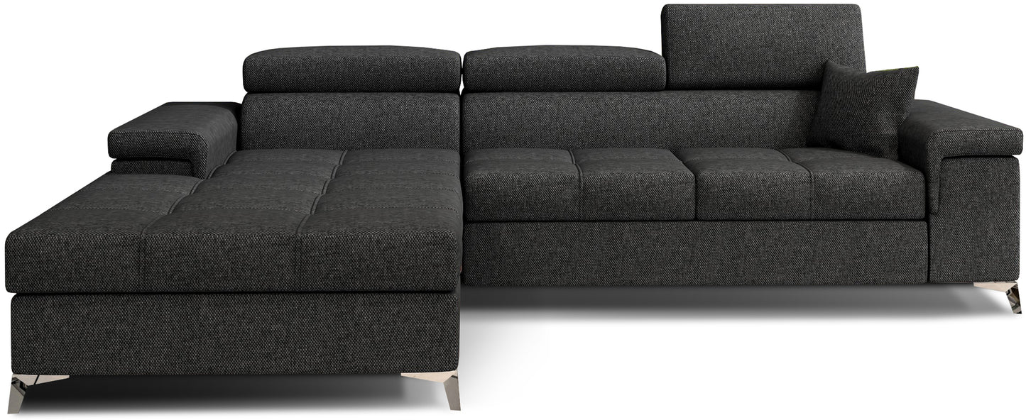 Narożnik Ricardo w układzie lewym, tapicerowany tkaniną Inari 96 ciemnoszary, z regulowanymi zagłówkami, szerokimi podłokietnikami i poduszką dekoracyjną, prezentowany na białym tle.