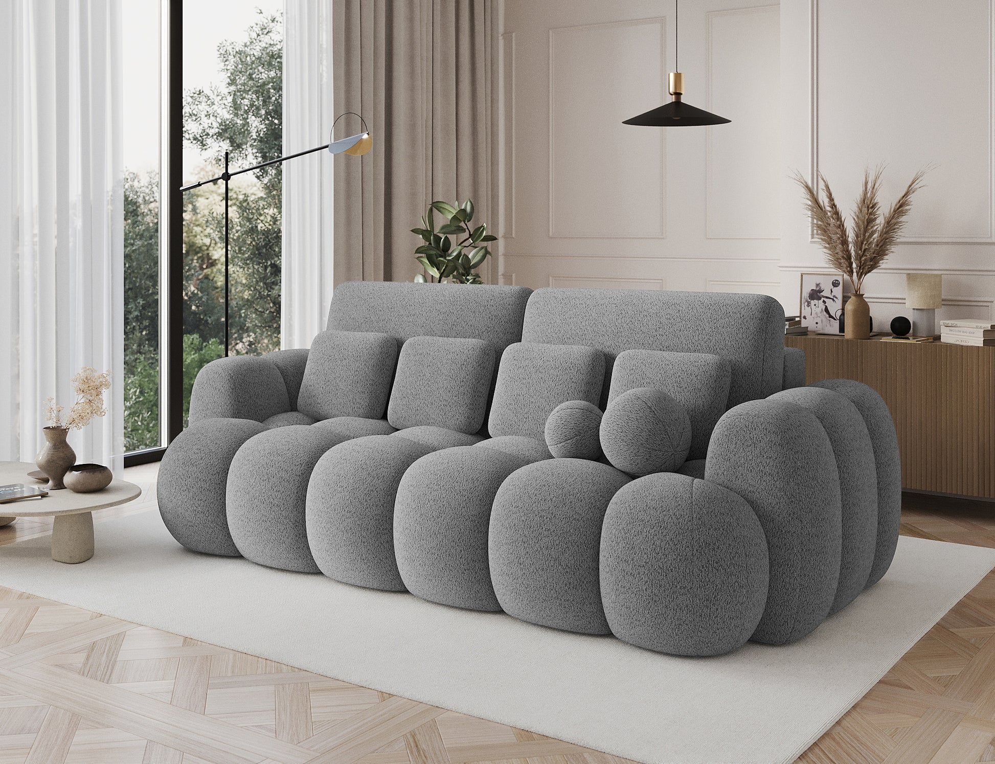 Big sofa Cotonn Royal 04 szary w nowoczesnym wnętrzu, widok z boku, elegancki design i poduszki w komplecie.