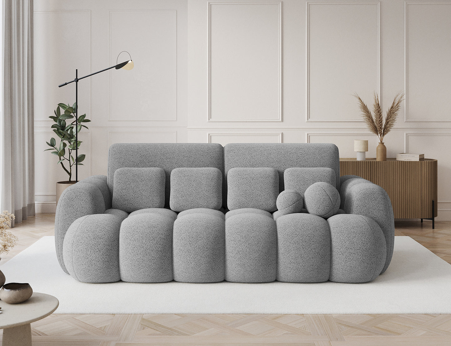 Big sofa Cotonn w tkaninie Royal 04 szary w eleganckim wnętrzu, ustawiona na jasnym dywanie w stylowym salonie.