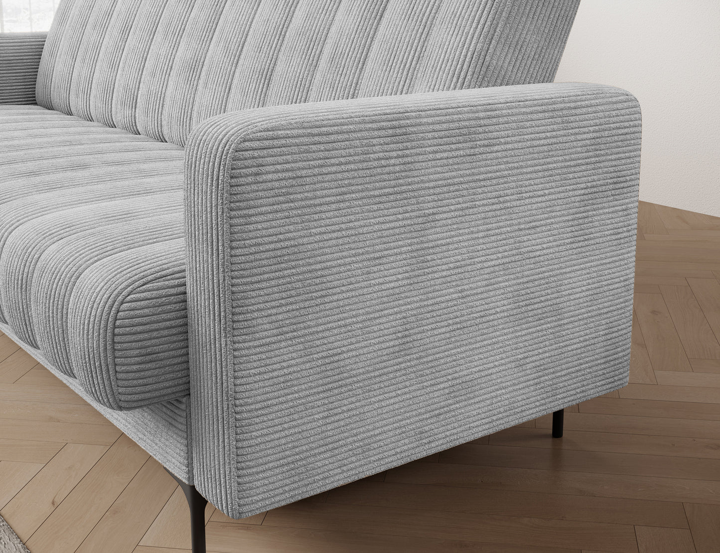 Zbliżenie na bok sofy Roneyy w tkaninie Jarell 04 jasnoszary – miękkie linie i starannie wykonane przeszycia.