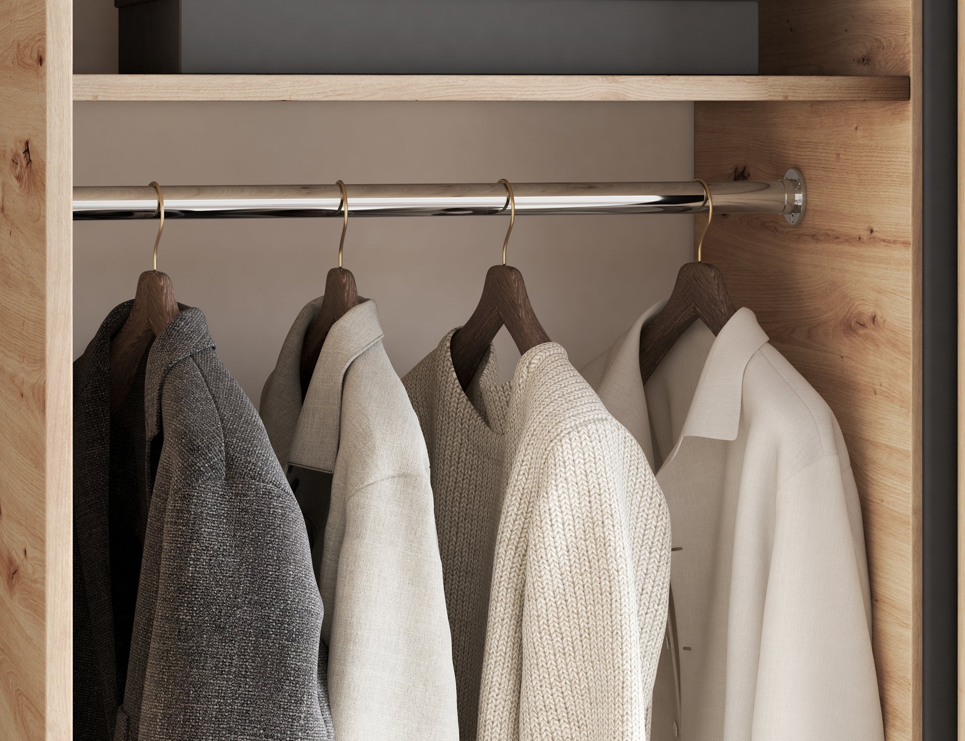 Zbliżenie na wnętrze szafy Emerio II z drążkiem na wieszaki. Praktyczne i eleganckie rozwiązanie do wygodnego przechowywania ubrań.