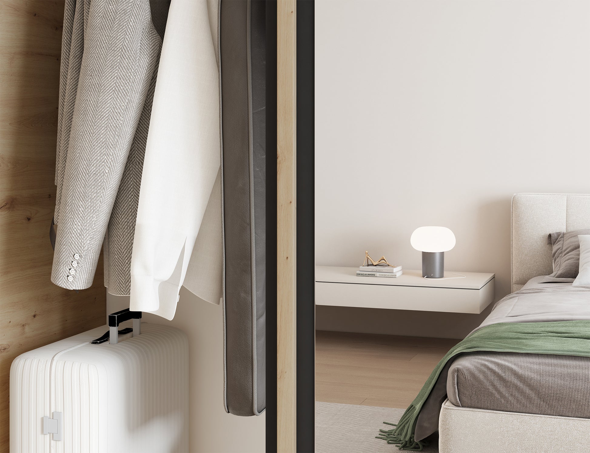 Zbliżenie wnętrza szafy Emerio III z zawieszonymi ubraniami i walizką w dolnej części, widoczne łóżko w tle kadru.