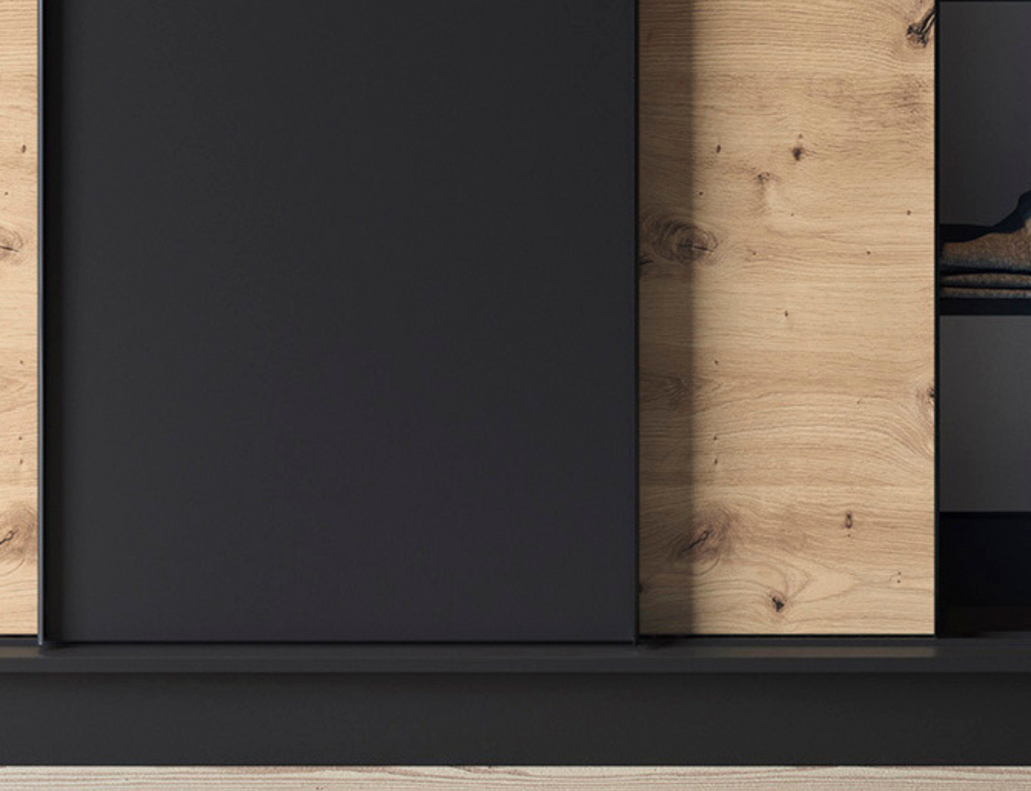 Zbliżenie na strukturę frontu szafy Esville III czarny dąb artisan, widoczny dekor drewna i elegancki nowoczesny design
