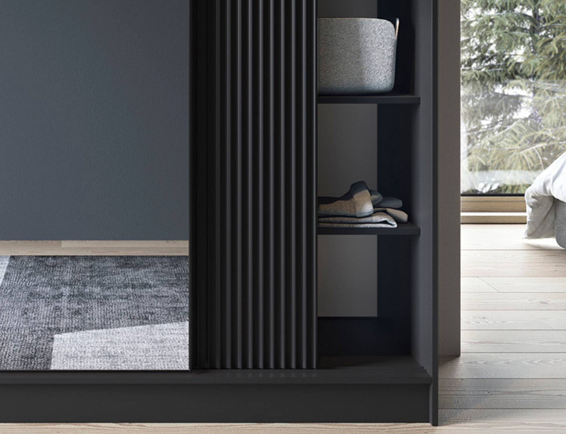 Zbliżenie na ryflowane fronty i fragment lustra szafy Prescco III czarnej.